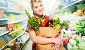 woman shopping for fruits and vegetables in produce department o
